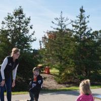 Mom and her son and daughter playing corn hole